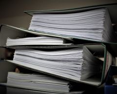 pile of court bundles for the article technological change long overdue in family law cases.