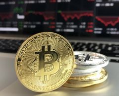 bitcoins hidden in divorce stacked in front of computer .
