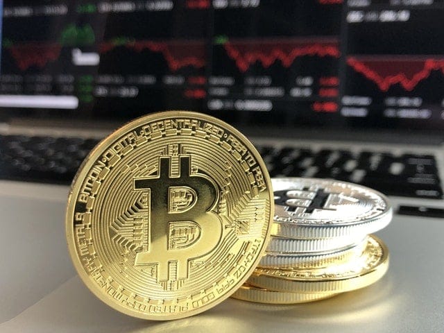 bitcoins hidden in divorce stacked in front of computer